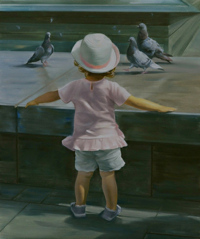 small child looks at pigeons with excitement